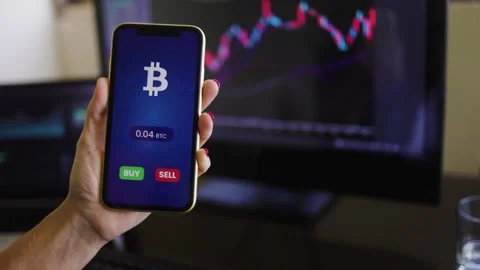 Busines s trader using crypto payment service app with mobile phone for Bitcoin  Stock Footage 270365552