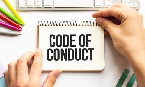 Businesman hold notepad with text CODE OF CONDUCT. White background. Business Foto stock