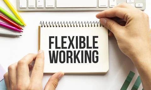 Businesman hold notepad with text FLEXIBLE WORKING. White background. Busines Stock Photos