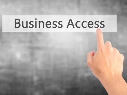 Business Access - Hand pressing a button on blurred background concept on vis Stock Photos