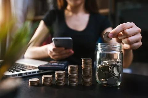 Business accountant working on desk using mobile phone and calculator to ca.. Stock Photos