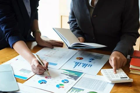 A business advisor explains graphs statistics and ways to increase profits .. Stock Photos