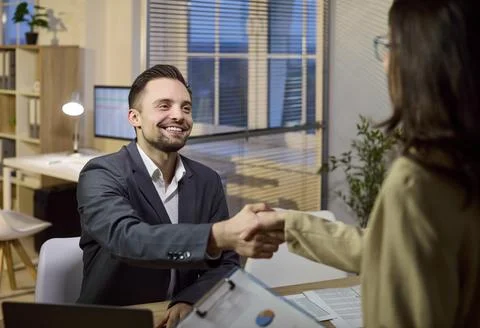 Business advisor shaking hands with client after consultation in bank office Stock Photos