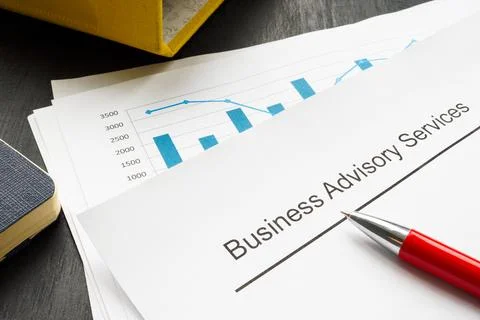 Business advisory services concept. A stack of financial charts and a folder. Stockfoto's
