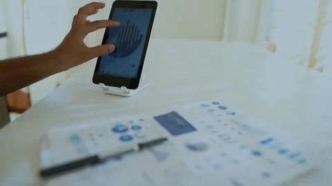 Business Analysis on Tablet with Documents Stock Footage 318578319