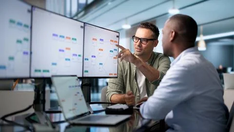 Business Analyst And Engineer Collaborate Optimizing Automated Workflow Effic Stock Photos