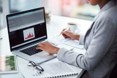 Business analyst with computer reading data, checking reports and monitoring Foto stock