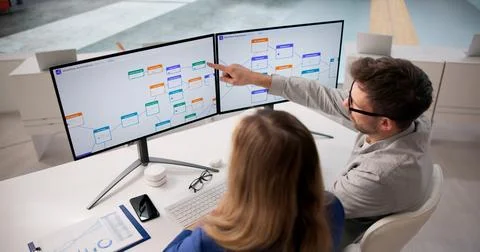 Business Analyst Evaluates Workflow Automation Software On Desktop For Enhanc Stock Photos