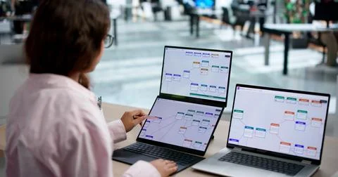 Business Analyst Improves Workflow Efficiency Using Dual Touchscreen Laptops. 写真素材