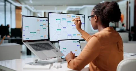 Business Analyst Reviews Data Workflows On Laptop To Optimize Automation Syst Stock Photos