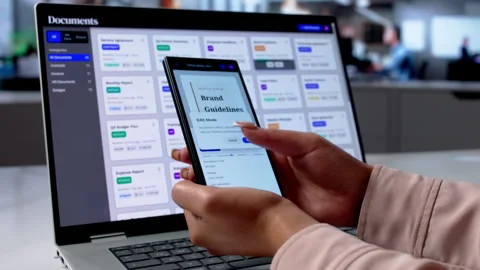 Business Analyst Reviews Document Workflow Using Smartphone Stock Footage 335459521