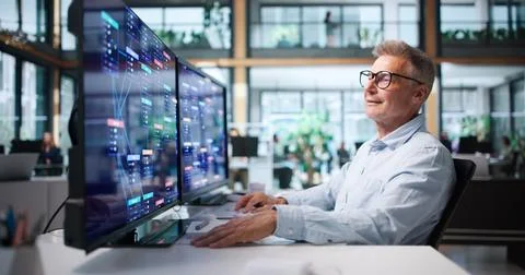 Business Analyst Reviews Low Code Platform Workflow On Desktop Computer. Photos