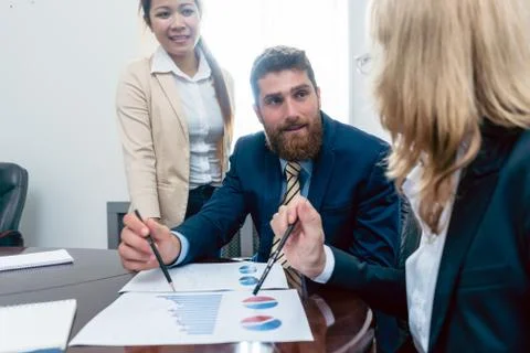 Business analyst smiling while interpreting financial reports sh Stock Photos