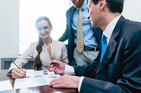Business analyst smiling while interpreting financial reports Stock Photos