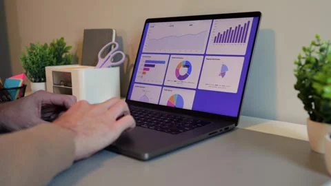 Business Analyst Sorting Through Graphs and Charts Stock Footage 320907672