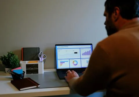 Business Analyst Sorting Through Graphs and Charts Stock Photos