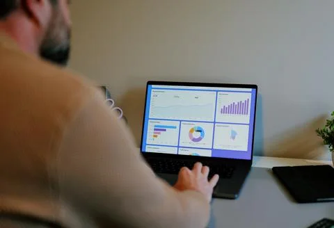 Business Analyst Sorting Through Graphs and Charts Stock Photos