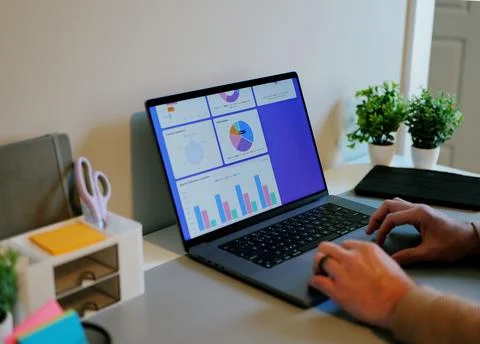Business Analyst Sorting Through Graphs and Charts Stock Photos