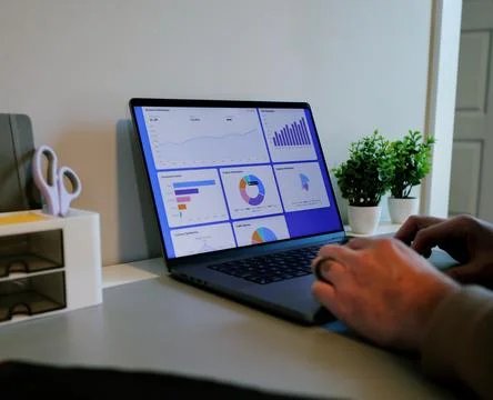 Business Analyst Sorting Through Graphs and Charts Stock Photos