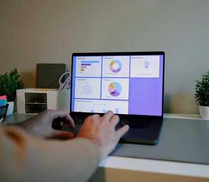 Business Analyst Sorting Through Graphs and Charts Stock Photos