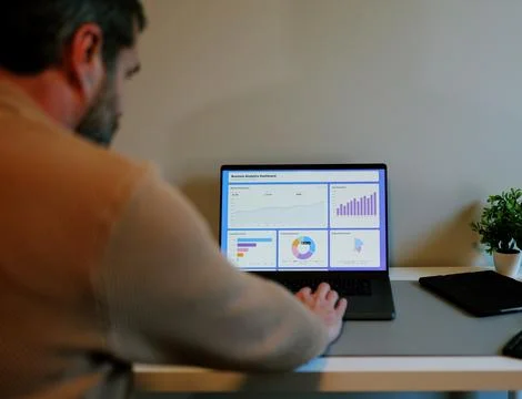 Business Analyst Sorting Through Graphs and Charts Stock Photos