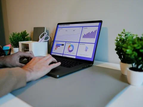 Business Analyst Sorting Through Graphs and Charts Stock Photos
