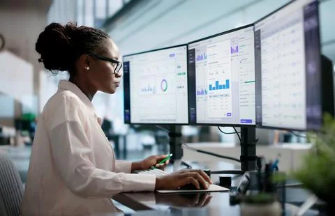 Business Analyst Studies Real-time Dashboards For Clear Data Insights. Stock Photos