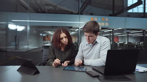 Business analysts looking at charts and discussing progress Stock Footage 147671122