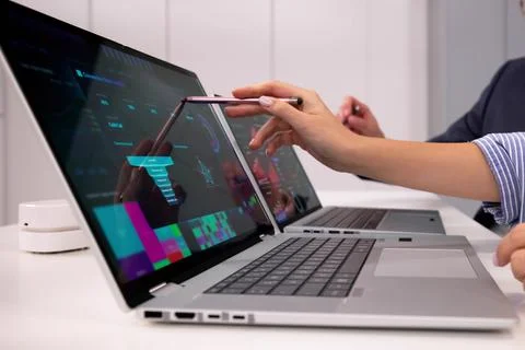 Business Analysts Review Data On Computer Dashboard In Office Workplace Stock Photos