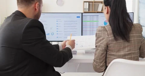 Business analysts reviewing data dashboard on computer in teamwork office Stock Footage 340853560