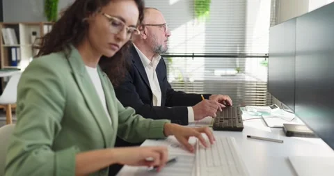 Business analysts working on budget and finance at computers in modern office Stock Footage 332426732