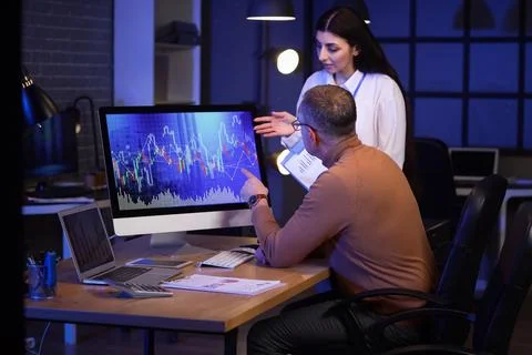 Business analysts working with computer in office at night. Data science conc Stock Photos