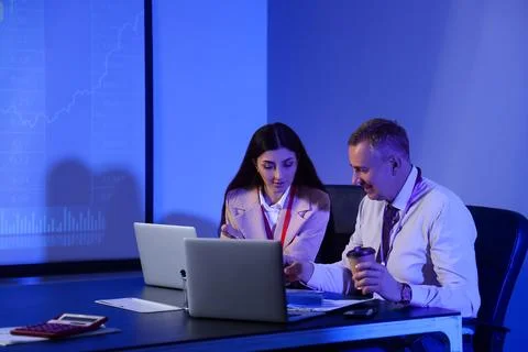 Business analysts working at table in dark office. Data science concept Stock Photos