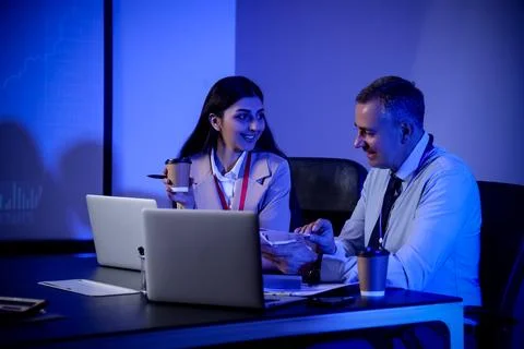 Business analysts working at table in dark office. Data science concept Stock Photos