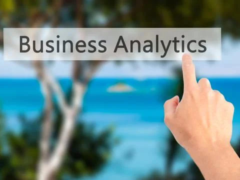 Business Analytics - Hand pressing a button on blurred background concept on  Stock Photos