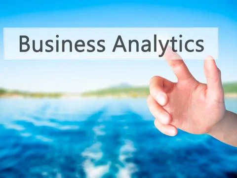 Business Analytics - Hand pressing a button on blurred background concept on  Stock Photos