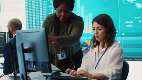 Business associates comparing key performance indicators within the firm Stock Footage 276244849