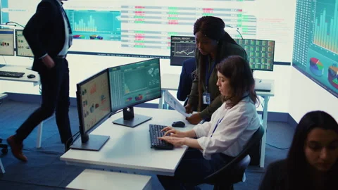 Business associates comparing key performance indicators within the firm Stock Footage 276336720