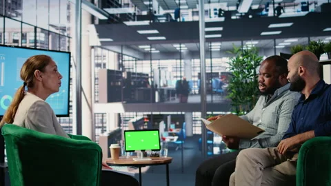 Business associates doing kpi analysis next to isolated device screen Stock Footage 309393874