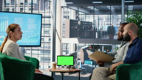 Business associates doing kpi analysis next to isolated device screen Stock Footage 309396306
