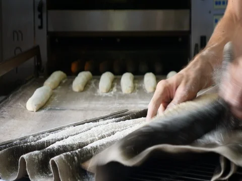 Business baker making bread cooking industrial oven organic baguette whole grain Stock Footage 84077120