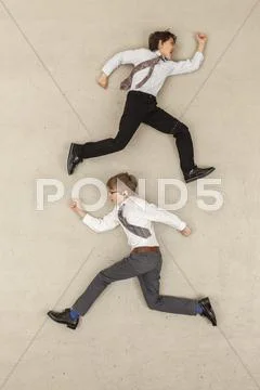 Business boys running in opposite direction Stock Photos