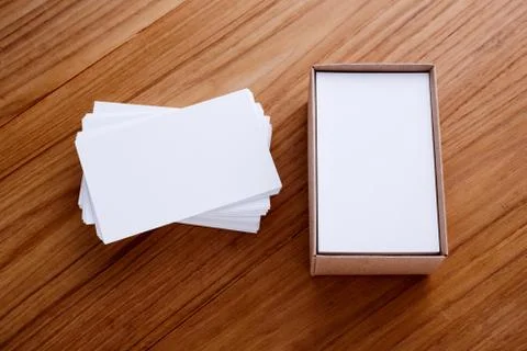 Business card blank stack mockup with kraft box on wood desk Stock Photos
