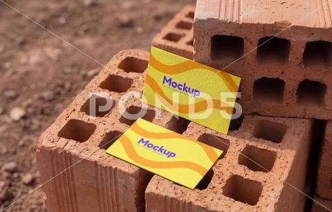 Business card mockup for construction work on top of bricks PSDテンプレート