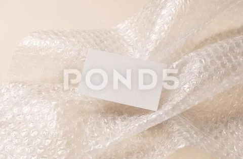 Business card mockup floating in bubble wrap PSD Template