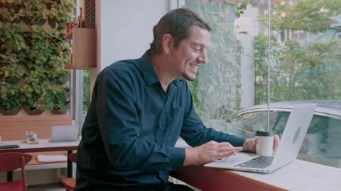 A business caucasian man is using computer video calling to his friend in cof Stock Footage 171380329