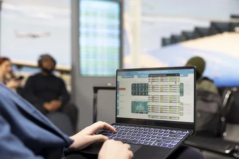 Business CEO evaluating company data and KPIs working on laptop in airport Stock Photos