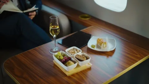 Business class luxury flight service with snacks and champagne on private j.. Stock Footage 337542460