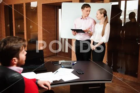 Business coach holding training for staff in office. Stock Photos