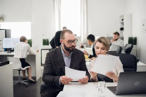 The business coach instructs trainees in a spacious office. Training of Stock Photos